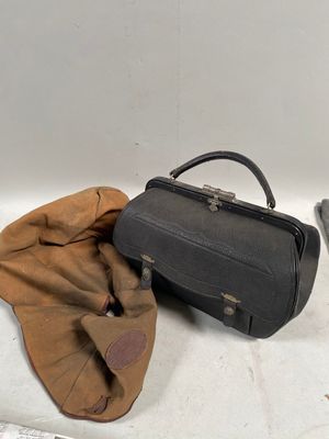 un sac noir et un sac marron posés sur une table