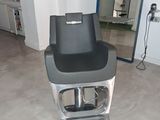 a black and silver chair in a room with a mirror