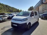 la camionnette blanche est garée devant un bâtiment dans un parking