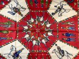 a red table cloth with a picture of a horse and rider on it