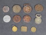 several coins and a medal are sitting on a table next to each other