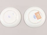 pair of chinese porcelain plates with blue and white designs on them
