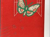 a close up of a red book with a butterfly on it