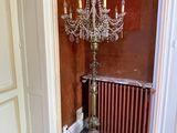 a chandelier in the corner of a room with a radiator in the corner