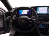 the interior of a car with a steering wheel, dashboard, and display screen