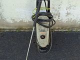 a pressurer that is sitting on the ground next to a wall