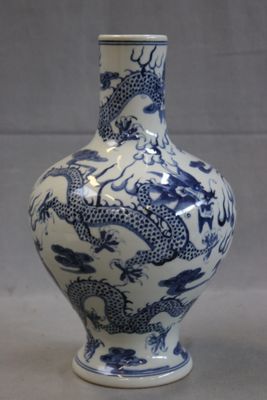 a blue and white vase with a dragon design on it