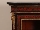 a black and red cabinet with a gold decoration on it