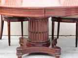 a wooden table with four chairs around it
