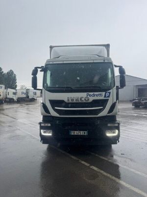 a truck that is driving down the road in the rain