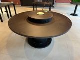 a table with a bowl on top of it in the middle of a room