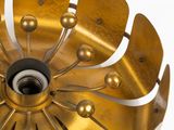 a large gold metal fan on a white background