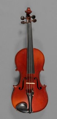 an old violin sitting on top of a table next to a gray wall
