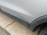 a close up of the side of a car on the side of the road