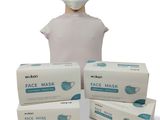 three boxes of face masks and a mannequin head on a white background