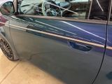a blue car that is parked in a garage