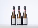 three bottles of wine sitting on top of a table