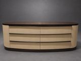an oval coffee table with three drawers and a wooden top