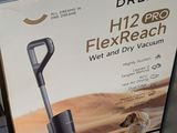 packaging of a black and white vacuum sitting on top of a table