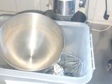 a large metal bowl sitting on top of a kitchen counter