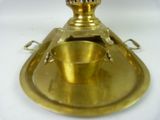 a brass oil lamp that is sitting on a tray