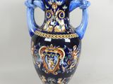 a blue and gold vase with handles on a white background