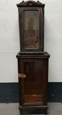 an old wooden cabinet with a mirror on it