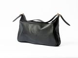 a black leather shoulder bag on a white background