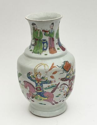 a white vase with a painting on it sitting on a table
