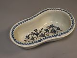a blue and white bowl with a flower design on it