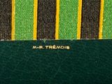 green and yellow striped purse with a name on the front