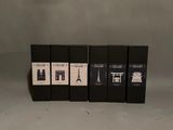 four black boxes of wine sitting on top of a white table