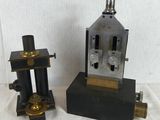 two different types of microscopes sitting on a table