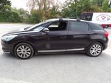 a picture of a black car parked in a parking lot
