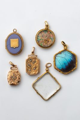 a collection of gold and enamel lockes and pendants