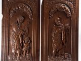 a pair of carved wood panels depicting jesus and a dog
