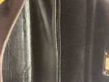 the inside of a black purse with a chain hanging from it