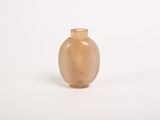 a small glass vase sitting on a white surface