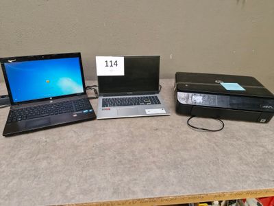 three laptops sitting on a table next to each other