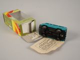 a small toy car sitting next to a box of tissues