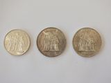 three british coins, one of which is a sovereign and one of which is a sovereign