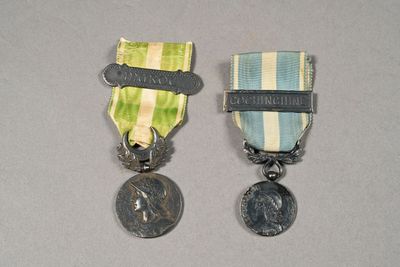 two medals that are sitting next to each other