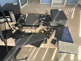 a desk with a lot of computer equipment on top of it