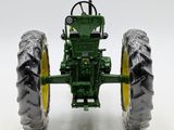 a toy tractor that is sitting on a white surface
