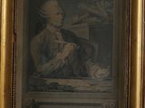 framed picture of a man sitting at a desk with a cat