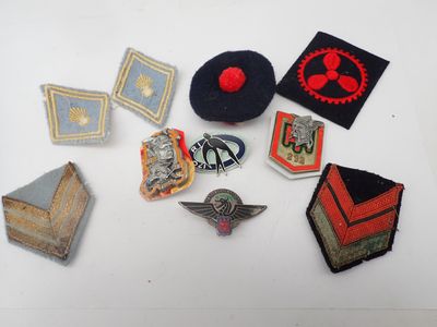 several different types of military badges are arranged on a white surface