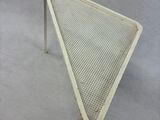an image of a white metal table with a mesh top
