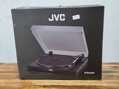 an open box of a record player sitting on top of a wooden table