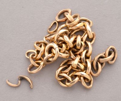 a pile of gold chains on a table