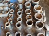 a lot of old metal pipes and fittings on a table